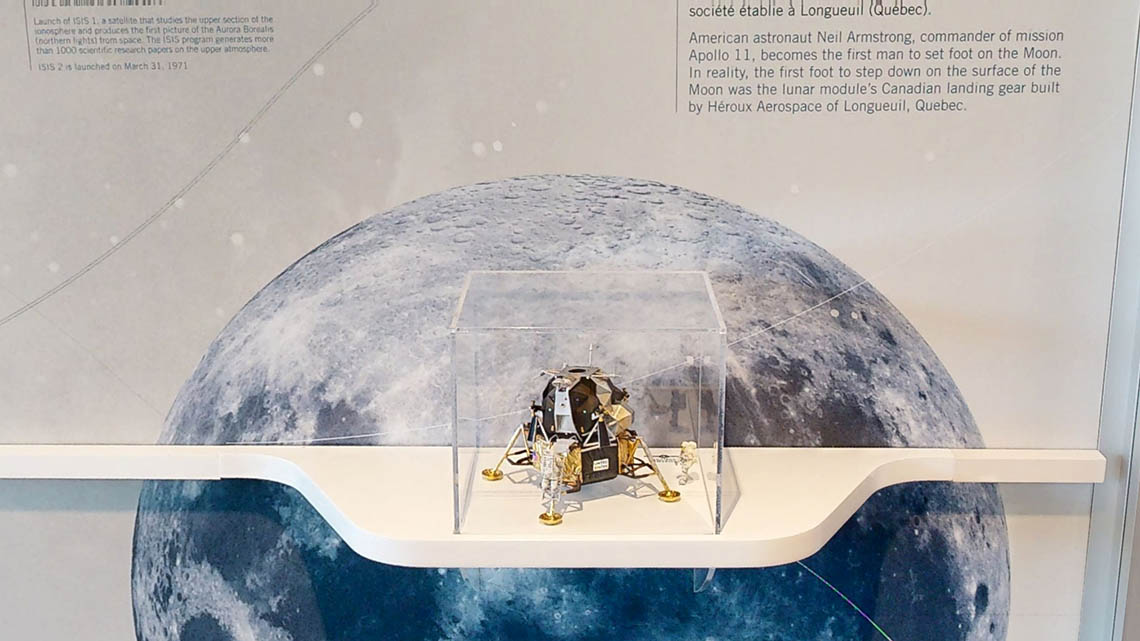 A model of the Apollo lunar module with a tiny astronaut.