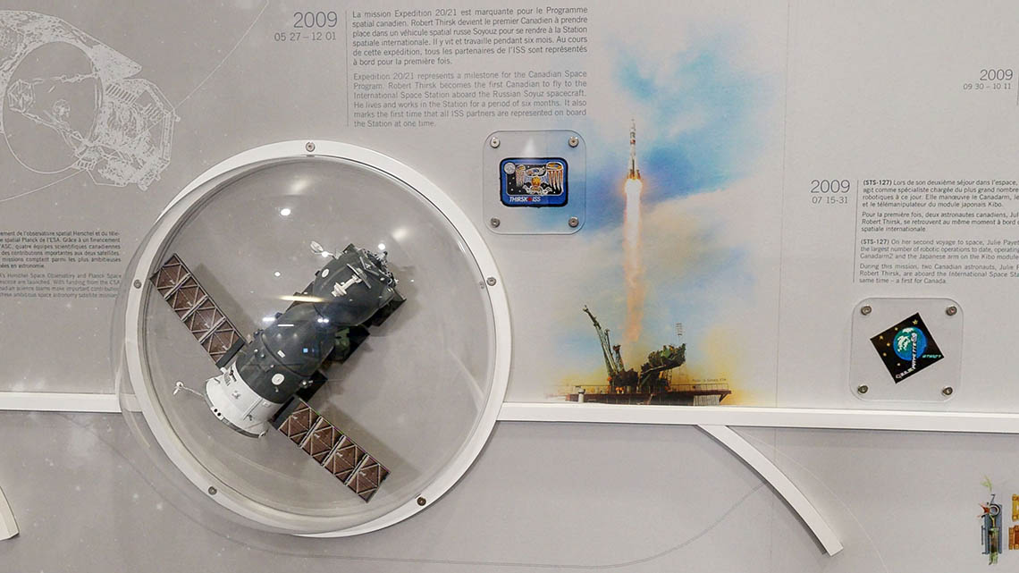 Small model of the Planck Space Telescope, and patches from Expedition 20/21 and mission STS-127.