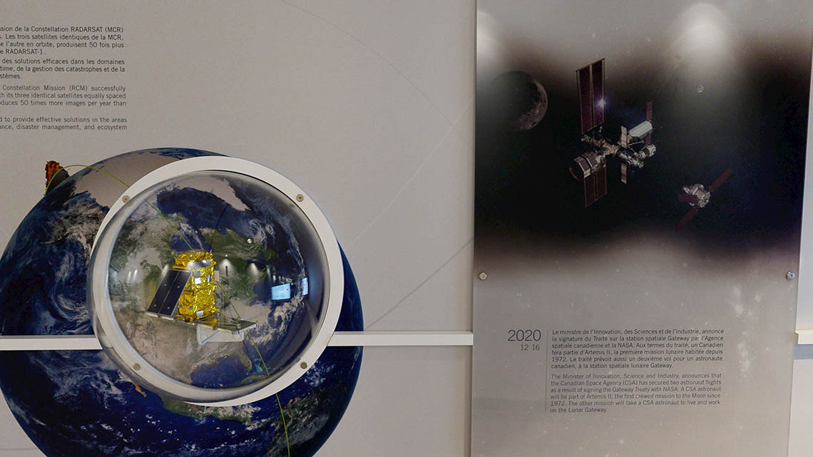 Small model of a RADARSAT Constellation Mission satellite, next to a panel featuring Gateway.