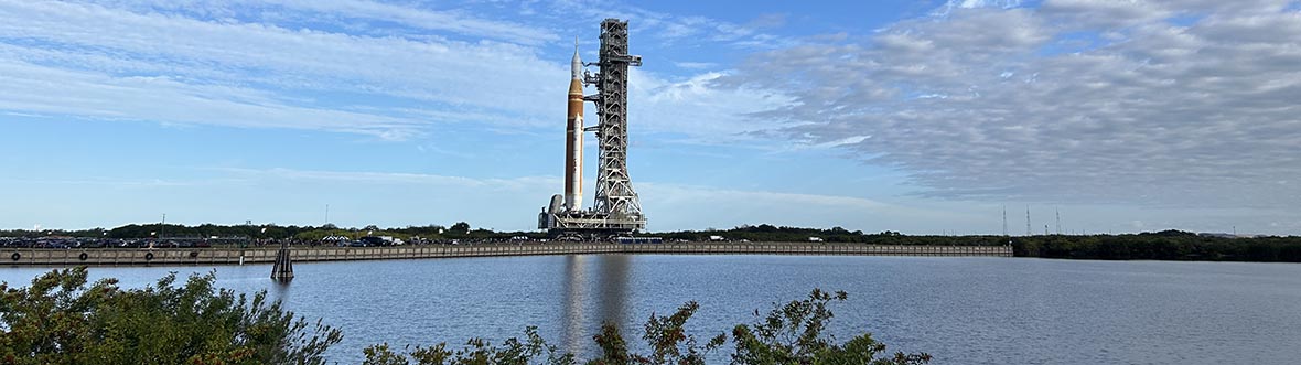 Artemis II's SLS rocket in vertical position on a crawler-transporter.