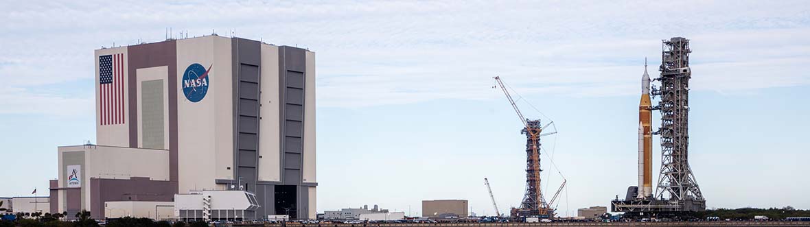 Artemis II's SLS rocket in vertical position on a crawler-transporter.