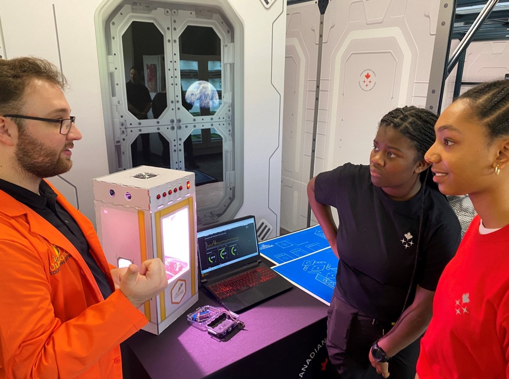 Chris Seymour of Ulnooweg Education Centre speakes with two WIBCA participants.