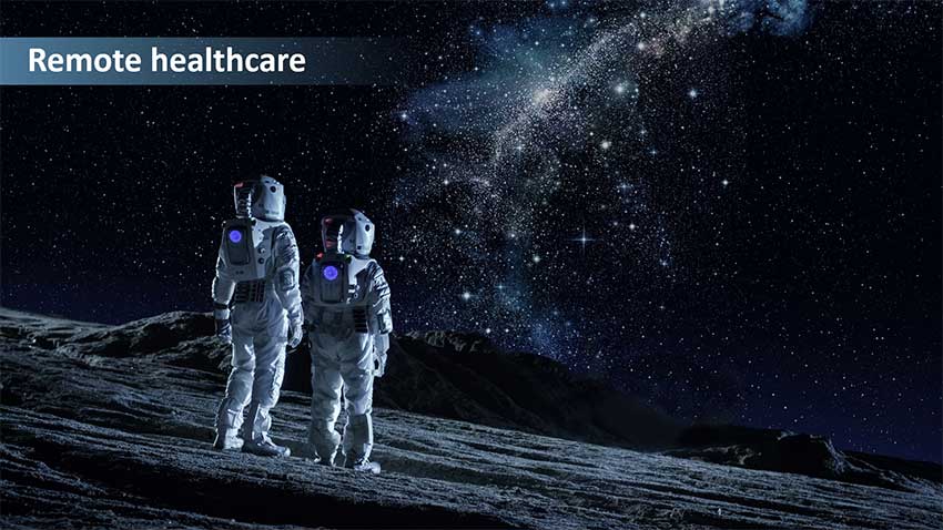 Artist's concept of two people in white space suits on a planetary surface. They are examining a plant.