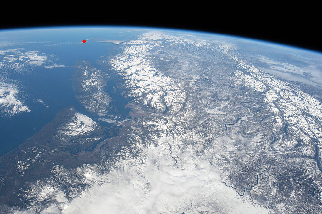 Canada has one of the oldest and largest national parks systems in the world. Gwaii Haanas National Park Reserve, National Marine Conservation Area and Haida Heritage Site is located at the southern tip (red dot) of an island 130 km off the coast of British Columbia, which faintly appears in this photo of Canada's west coast taken by David Saint-Jacques from the International Space Station. It is also a UNESCO World Heritage site and a National Historic site of Canada. (Credit: Canadian Space Agency/NASA)