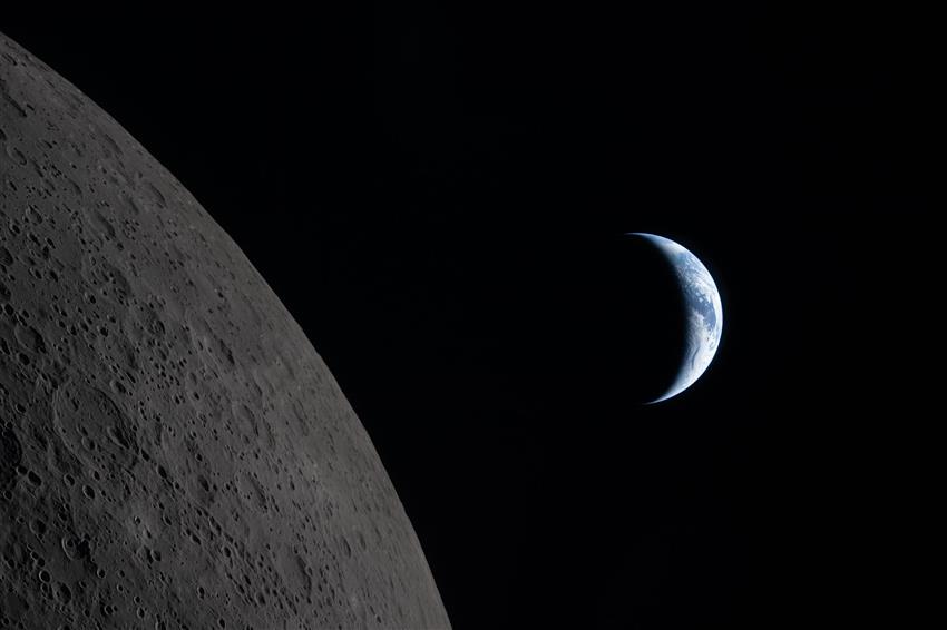 The edge of the Moon and a crescent Earth. 