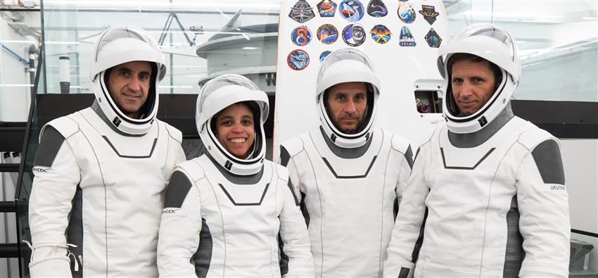 The four astronauts in their space suits. 