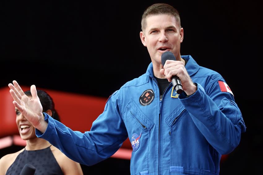 Astronaut Jeremy Hansen speaking on stage at the Canada Day daytime ceremony in Ottawa