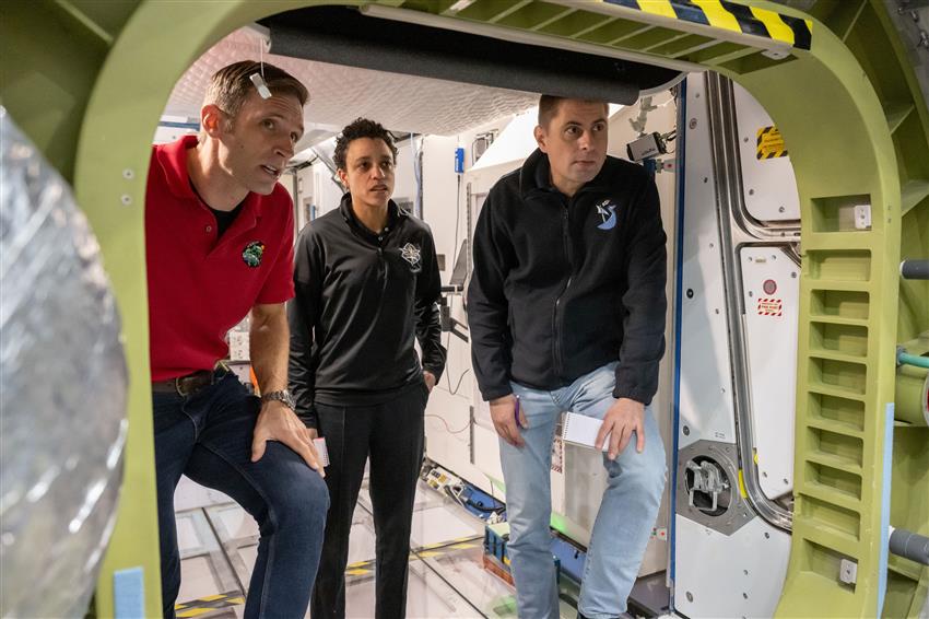 Joshua, Jessica, and Andrey in a mock-up of the International Space Station. 