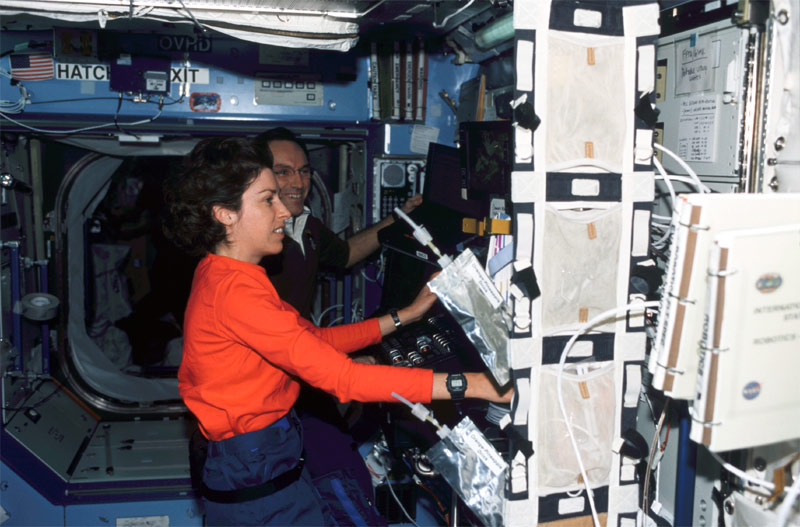 An astronaut operating the Canadarm